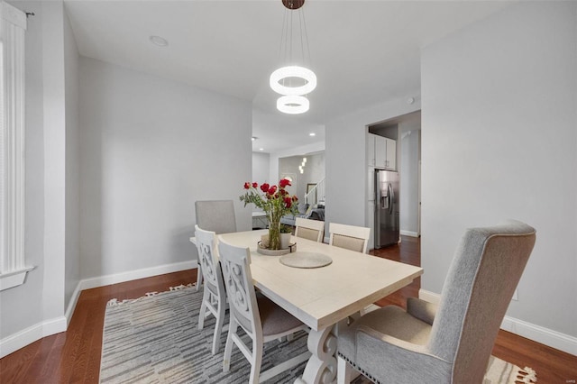 dining room with baseboards and wood finished floors