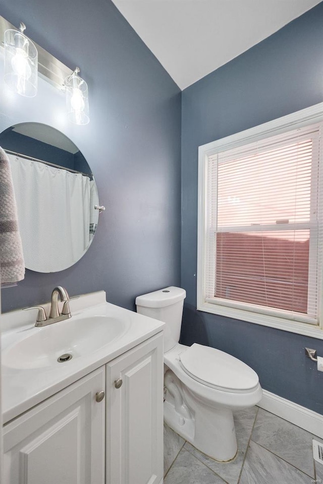 full bathroom with baseboards, plenty of natural light, vanity, and toilet