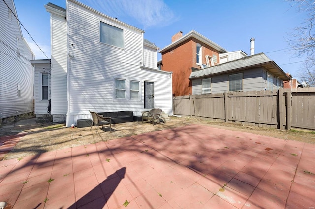 back of house featuring a patio area and fence