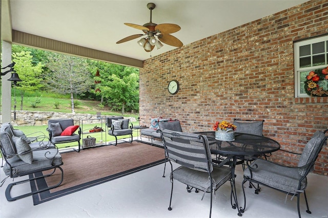 view of patio with outdoor dining area, an outdoor hangout area, and a ceiling fan