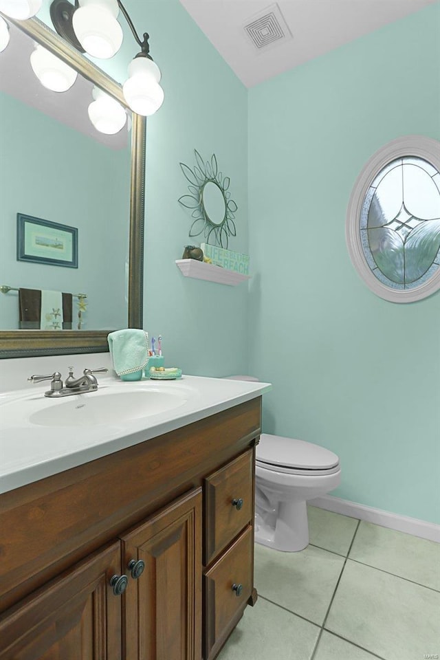 bathroom featuring toilet, vanity, visible vents, and tile patterned floors