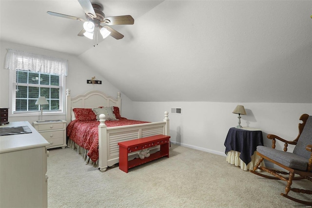 bedroom with light carpet, a ceiling fan, visible vents, vaulted ceiling, and baseboards