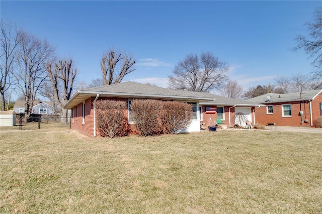 back of house with fence, a lawn, and brick siding