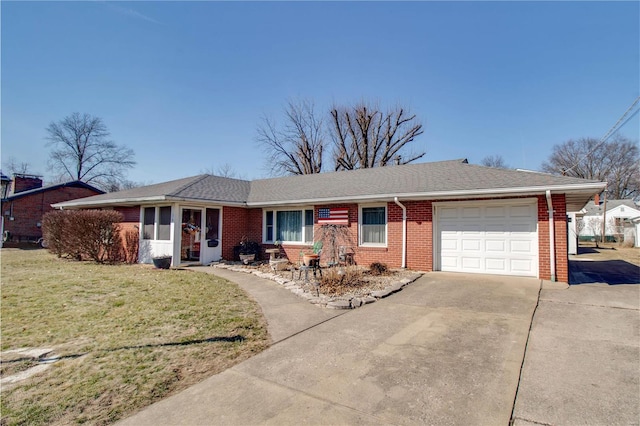 ranch-style home featuring driveway, brick siding, an attached garage, and a front yard