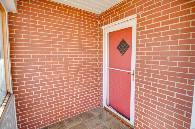 property entrance with brick siding