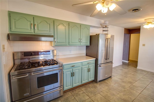 kitchen with tasteful backsplash, a ceiling fan, appliances with stainless steel finishes, under cabinet range hood, and green cabinetry