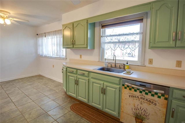 kitchen featuring a sink, green cabinets, stainless steel dishwasher, and light countertops