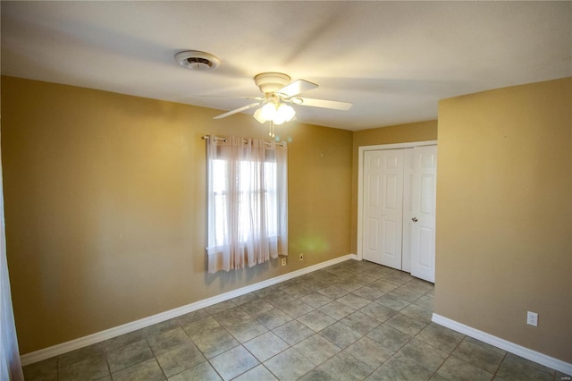 interior space with a ceiling fan, visible vents, and baseboards