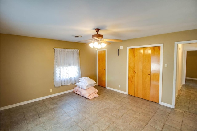 interior space with visible vents, baseboards, and ceiling fan