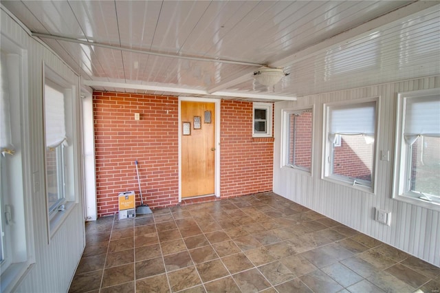 unfurnished sunroom featuring wooden ceiling