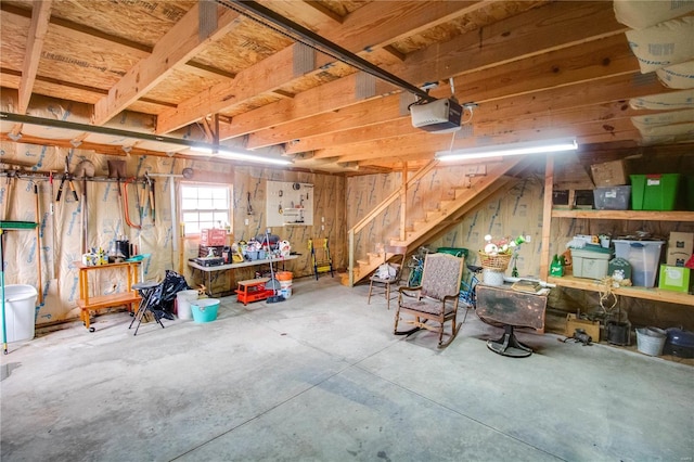 garage with a workshop area and a garage door opener