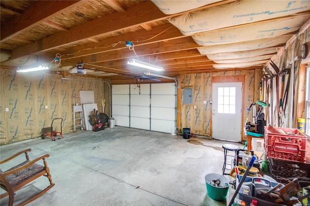 garage featuring a garage door opener and electric panel