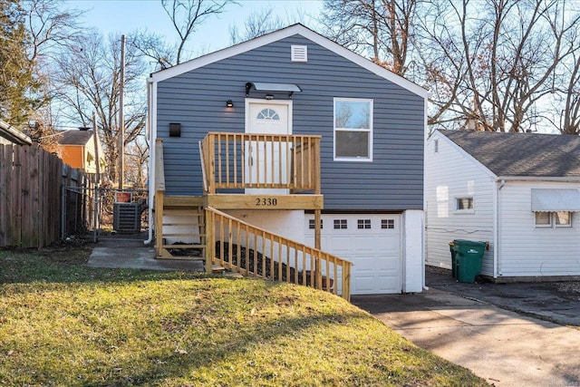 view of front of property with a front yard, central AC, fence, a garage, and stairs