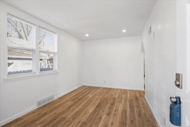 spare room featuring recessed lighting, baseboards, visible vents, and light wood finished floors