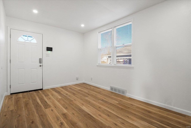 entrance foyer featuring recessed lighting, visible vents, baseboards, and wood finished floors