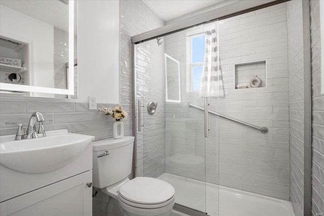 bathroom with backsplash, a shower stall, and toilet