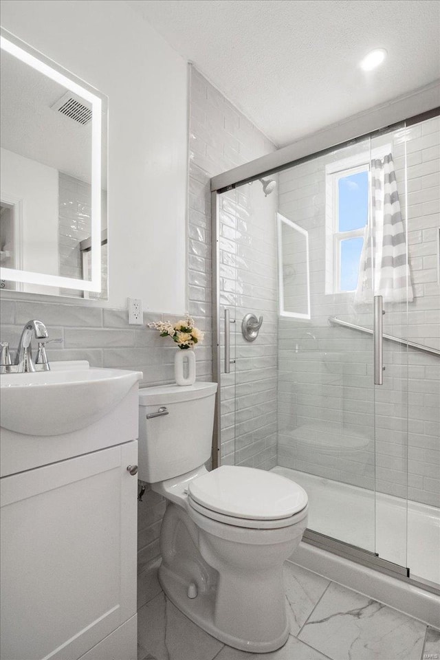 full bathroom with toilet, vanity, visible vents, marble finish floor, and a stall shower