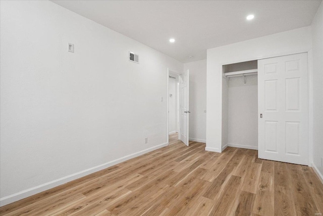 unfurnished bedroom with light wood finished floors, visible vents, and baseboards