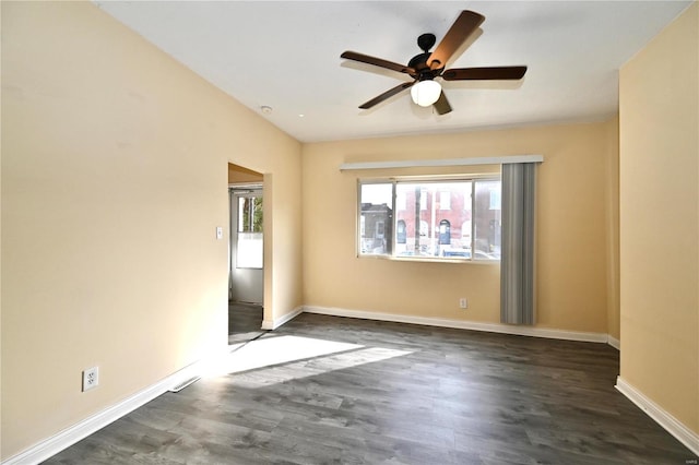 spare room with ceiling fan, baseboards, and wood finished floors