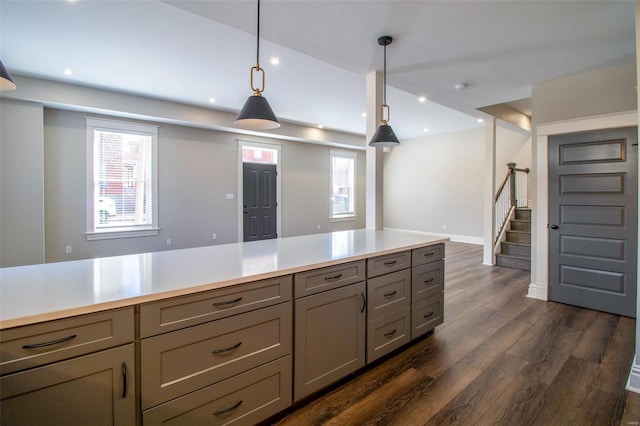 kitchen featuring dark wood-style flooring, hanging light fixtures, gray cabinets, light countertops, and recessed lighting