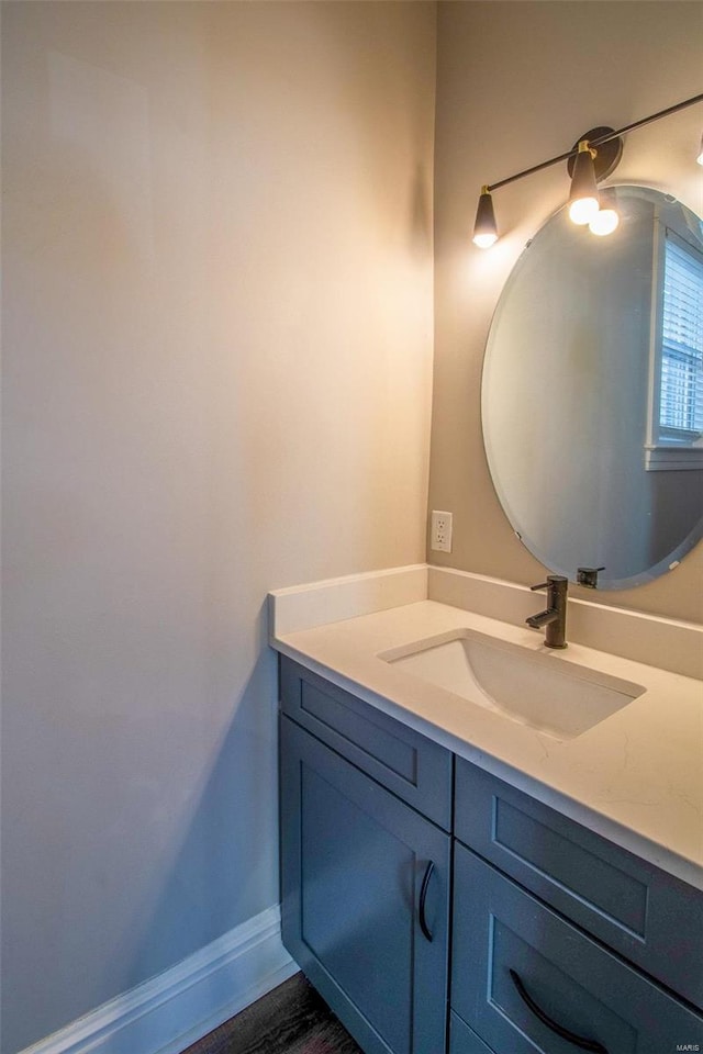 bathroom with vanity and baseboards