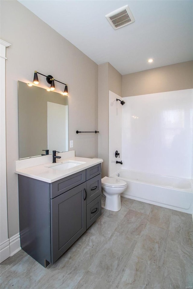 bathroom featuring washtub / shower combination, visible vents, vanity, and toilet