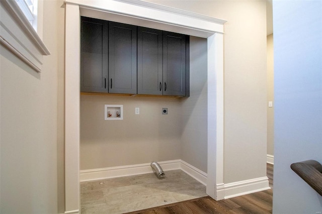 clothes washing area with washer hookup, cabinet space, hookup for an electric dryer, wood finished floors, and baseboards