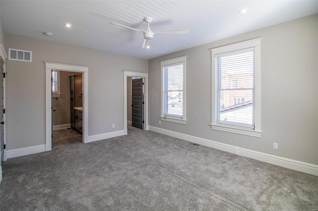 unfurnished bedroom featuring recessed lighting, carpet floors, visible vents, baseboards, and a walk in closet