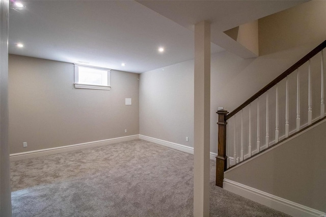 below grade area with stairs, baseboards, carpet flooring, and recessed lighting