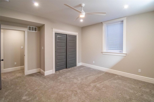 unfurnished bedroom featuring baseboards, visible vents, a ceiling fan, carpet flooring, and a closet