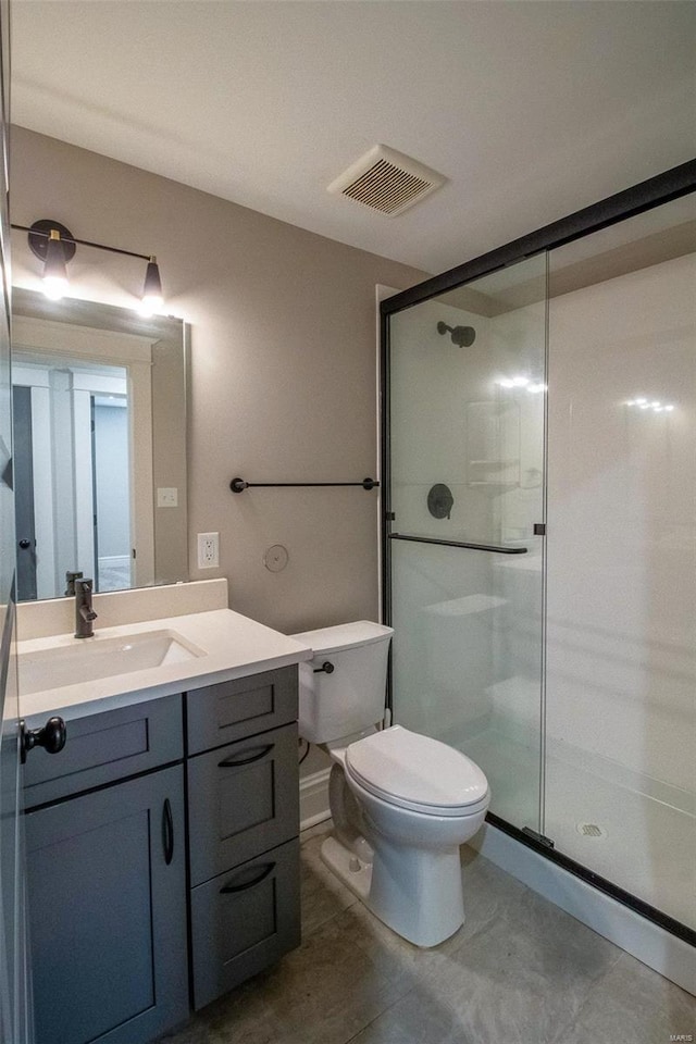 bathroom with toilet, a stall shower, visible vents, and vanity