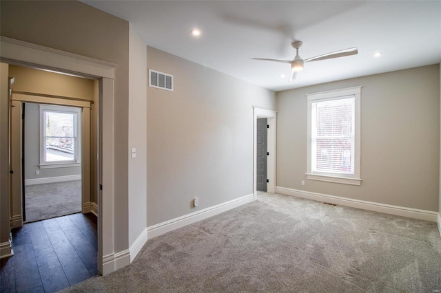 unfurnished room with carpet floors, recessed lighting, visible vents, ceiling fan, and baseboards