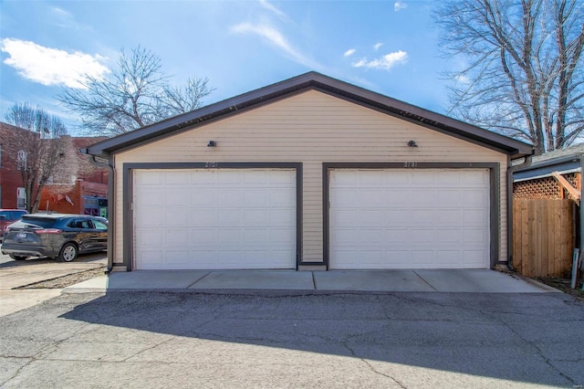 detached garage featuring fence