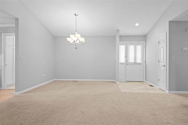 interior space featuring light carpet, a chandelier, and baseboards