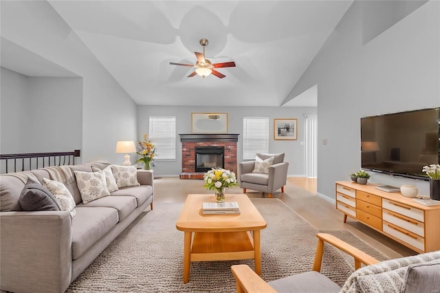 living room featuring a ceiling fan, a brick fireplace, vaulted ceiling, and baseboards