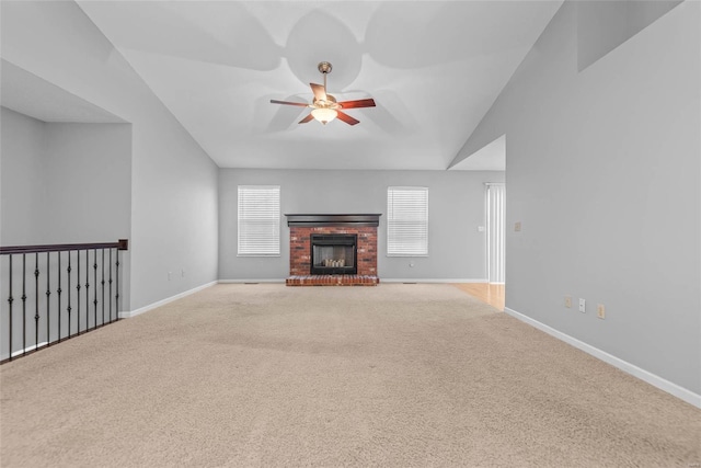 unfurnished living room featuring ceiling fan, a fireplace, baseboards, and carpet flooring