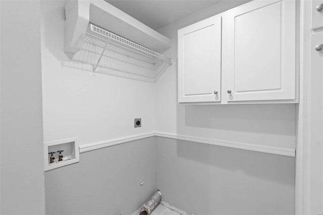 washroom with hookup for a washing machine, cabinet space, and electric dryer hookup