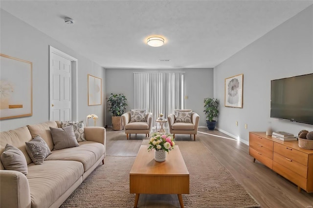 living area with wood finished floors and baseboards