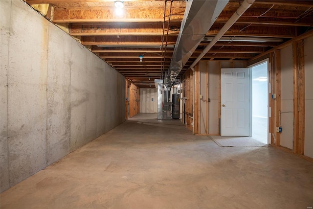 unfinished basement with water heater and heating unit