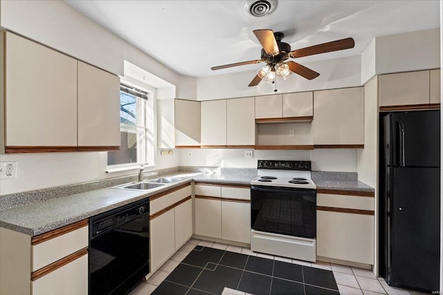 kitchen with light tile patterned floors, cream cabinets, a sink, visible vents, and black appliances