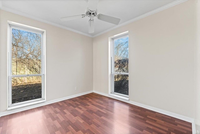 spare room featuring a ceiling fan, crown molding, baseboards, and dark wood-type flooring