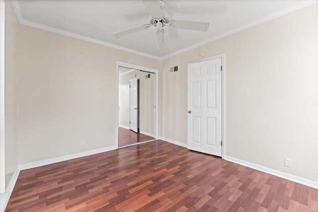 unfurnished bedroom featuring ornamental molding, visible vents, baseboards, and wood finished floors