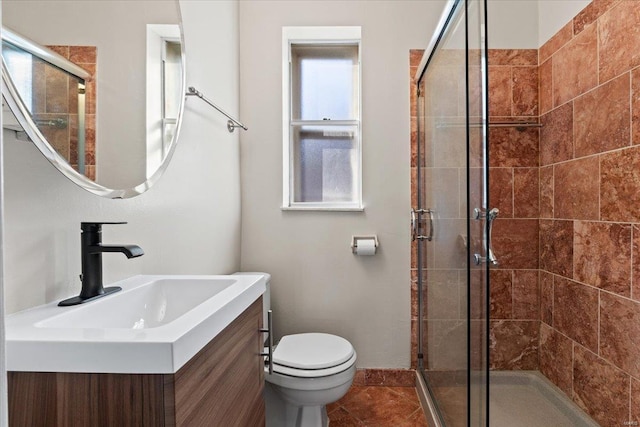 full bathroom featuring a stall shower, tile patterned flooring, vanity, and toilet