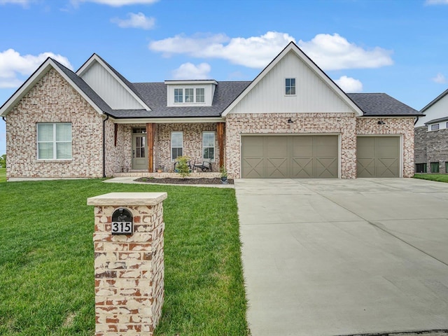 view of front of house featuring driveway, brick siding, an attached garage, and a front yard