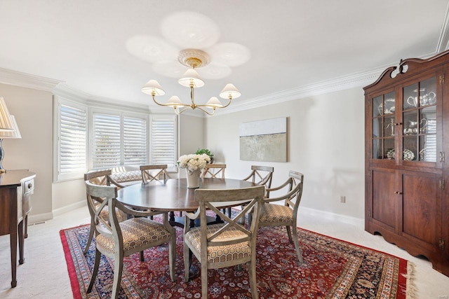 dining area with a chandelier, crown molding, and baseboards