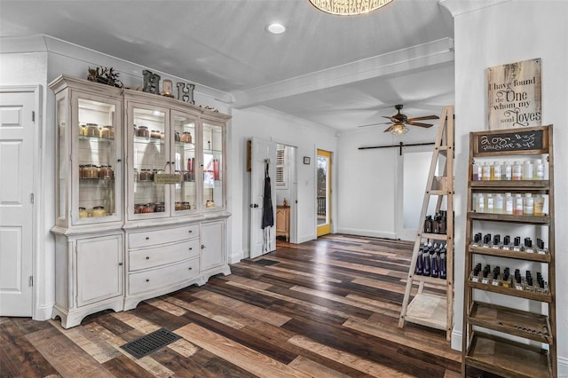 interior space featuring a barn door, baseboards, visible vents, dark wood finished floors, and a ceiling fan