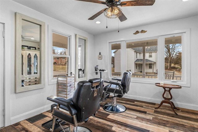 home office featuring a ceiling fan, visible vents, baseboards, and wood finished floors