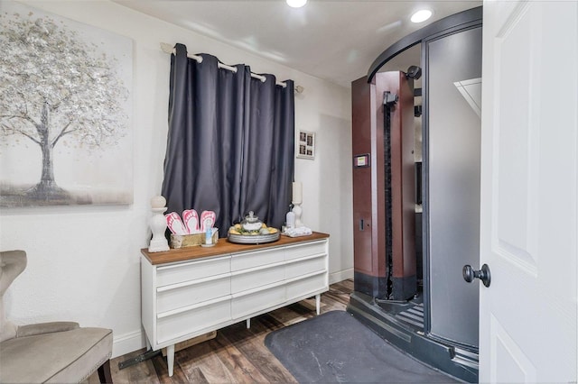 mudroom with arched walkways, recessed lighting, wood finished floors, and baseboards