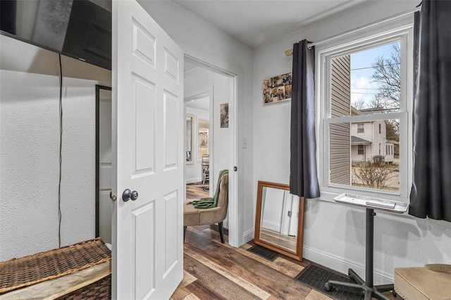 bathroom with wood finished floors and baseboards