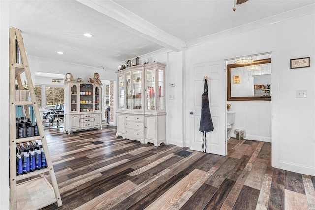 interior space with ornamental molding, recessed lighting, wood finished floors, and baseboards